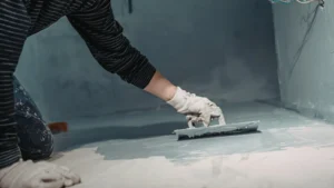Worker applying durable concrete floor finish in a high-traffic commercial environment